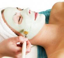 A detail image of a green apple mask being applied at a beauty spa.