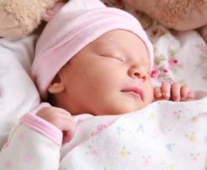 Portrait of a newborn girl sleeping.